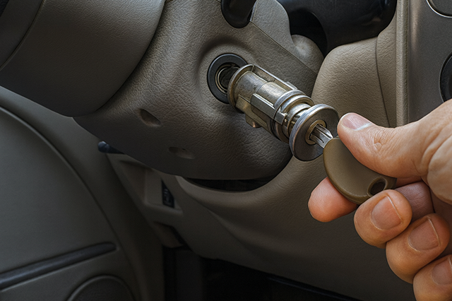 Mobile locksmith technician fixing broken car key ignition without towing