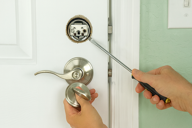 Locksmith repairing front door deadbolt at Issaquah home for better security